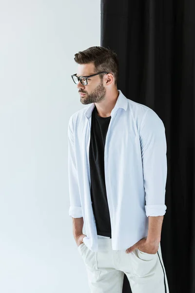 Fashionable Confident Man Wearing Glasses White Shirt Standing Black Curtain — стоковое фото