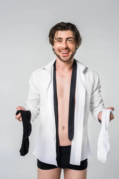 Portrait Smiling Young Man Shirt Underwear Holding Black White Socks — стоковое фото